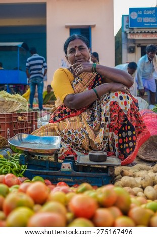 KAMALAPURAM, INDIA - 02 FEBRUARY 2015: Indian lady selling vegetables on a market close to Hampi.