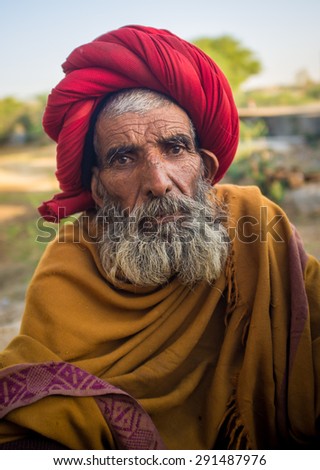 GODWAR REGION, INDIA - 14 FEBRUARY 2015: Elderly Rabari tribesman with red turban and blanket around the shoulders. Rabari or Rewari are an Indian community in the state of Gujarat.