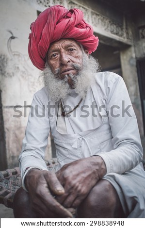 GODWAR REGION, INDIA - 12 FEBRUARY 2015: Elderly Rabari tribesman with traditional turban, clothes and long beard. Post-processed with grain, texture and colour effect.