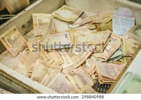 MUMBAI, INDIA - 05 FEBRUARY 2015: Desk drawer full of Indian rupees mostly with 10 rupee notes.