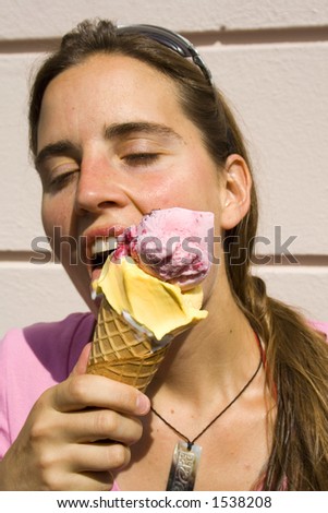 woman eating ice cream with eyes closed