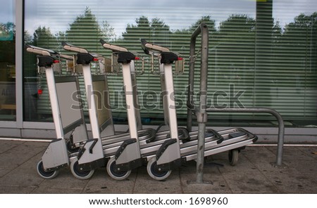 chained trolleys in line at airport