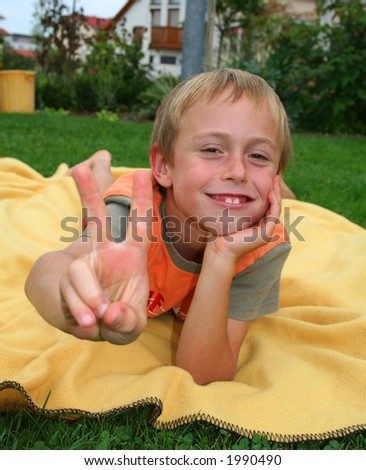 victory boy on blanket in garden