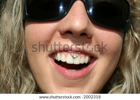 young woman smiling with great white teeth and diamond piercing in her upper lip