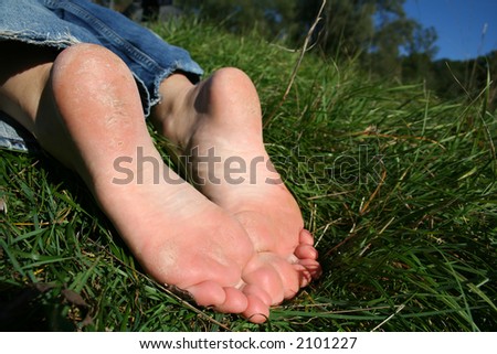 feet resting in the grass