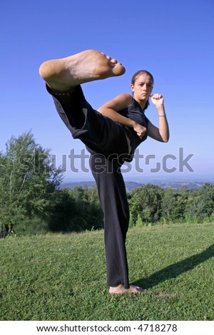 sole kick- attractive young woman practising self defense