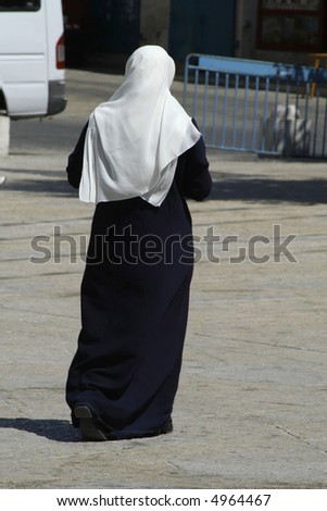 muslim lady walking in a street, bethlehem, west bank, palestine, israel