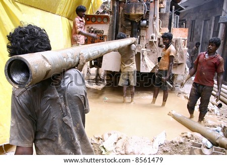 stock photo : labourers at construction site, delhi, india