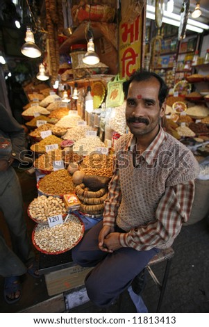smiling dried fruit vendor in delhi, india
