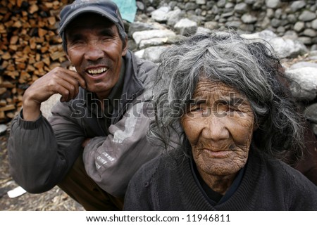poor old lady and her blind son, annapurna, nepal