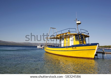 Yellow diving boat in harbour on Brac island in Croatia