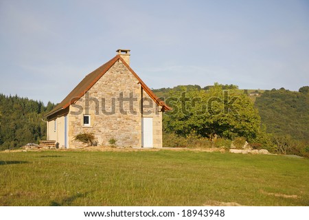 Stone house on hill in green garden, Correze, France