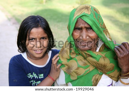 Delhi, India - May 2008. Young modern Indian daughter with old traditional grandmother. This demonstrates the changes of times in India where the young generations want to turn towards western ideals.