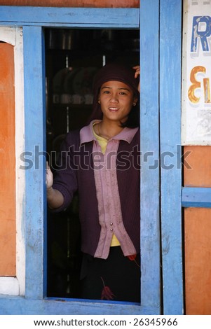 ANNAPURNA, NEPAL - MAR 19 : A young girl in her shop shed selling food and drinks to trekkers on March 19, 2008 in Annapurna, Nepal. Annapurna region is well known for its trekking activities.