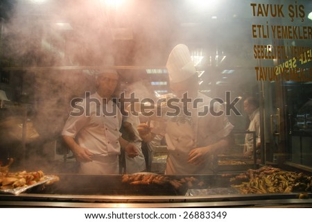ISTANBUL - JULY 25 : Cooks prepare food in busy pedestrian area of Taksim in Istanbul, Turkey on July 25, 2007. Istanbul generates 21.2% of Turkey\'s gross national product.