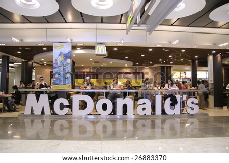 MADRID, SPAIN - AUGUST 7 : Customers having their meals at McDonald\'s Madrid airport in Madrid, Spain on August 7, 2007. Madrid’s metropolitan area is the fourth most populous area in Europe.