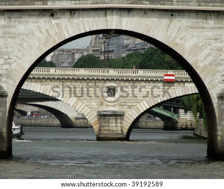 Parisian bridge archway with view to distant stone bridge