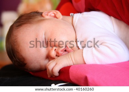 Newborn baby child getting some rest on pillow