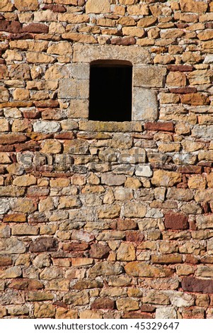 Background view of orange and red stone wall with window opening