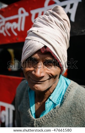 DELHI - FEBRUARY 12: Smiley portrait of a day labourer on February 12, 2008 in Delhi, India. These men sit on the street waiting to get day jobs not paid more than 2,5 dollars a day.