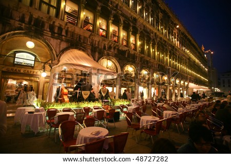 VENICE - OCTOBER 28: An orchestra plays on a St Mark\'s Square cafe on October 28, 2009 in Venice, Italy. Since the 16th century it has been the venue of night entertainment.