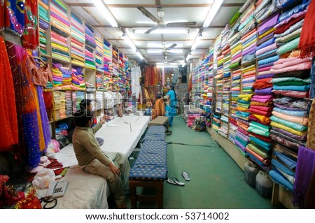 DELHI - JAN 19: Ladies choosing fabric for saris in textile shop on January 19, 2008 in Delhi, India. Saris can range from four to nine metres in length.