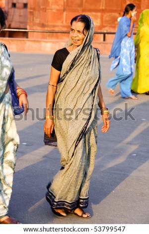 DELHI - SEP 22: Middle-aged woman on street wearing traditional sari  on September 22, 2007 in Delhi, India.  Saris are wrapped around the body, 4 to 8 metres in length.