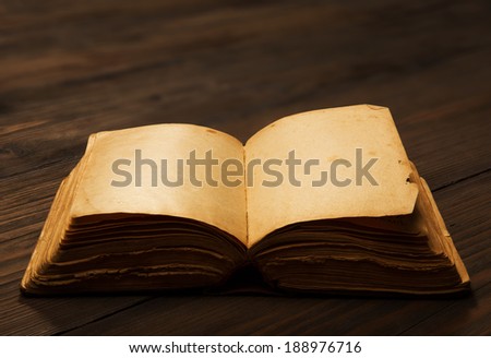 old book open blank pages, empty yellow paper on dark brown wooden table