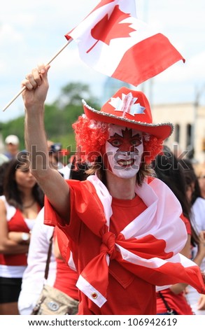 OTTAWA, CANADA - JULY 1: A man celebrating in the street on Canada Day, July 1, 2012 in Ottawa, Ontario. Canada Day is a national holiday, and is celebrated each July 1st across the country.