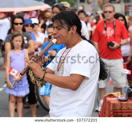 OTTAWA, CANADA - JULY 1: A man from Ecuador playing a flute on Canada Day, July 1, 2012 in Ottawa, Ontario. Canada Day is an annual holiday celebrated across the country.