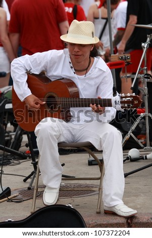 OTTAWA, CANADA - JULY 1: A man from Ecuador singing to the crowd on Canada Day, July 1, 2012 in Ottawa, Ontario. Canada Day is an annual holiday celebrated across the country.