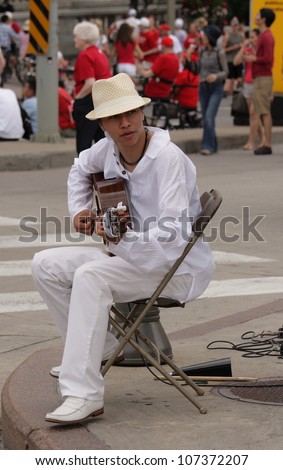 OTTAWA, CANADA - JULY 1: A man from Ecuador playing guitar on Canada Day, July 1, 2012 in Ottawa, Ontario. Canada Day is an annual holiday celebrated across the country.