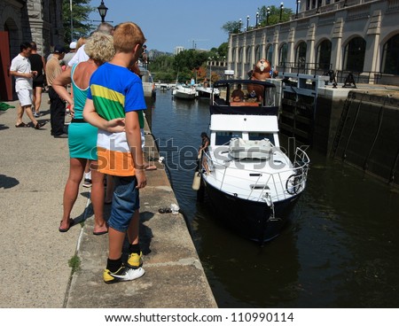 OTTAWA, CANADA - AUGUST 4: Boats traveling through the Ottawa Locks of the Rideau Canal, a UNESCO World Heritage Site, during the Rideau Canal Festival on August 4, 2012 in Ottawa, Ontario.