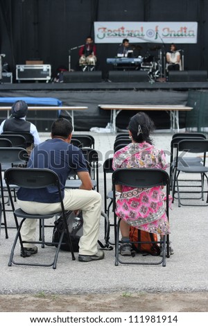 OTTAWA, CANADA-AUGUST 11: People watching musicians on stage during a sound check at the inaugural Festival of India on August 11, 2012 in Ottawa, Ontario.