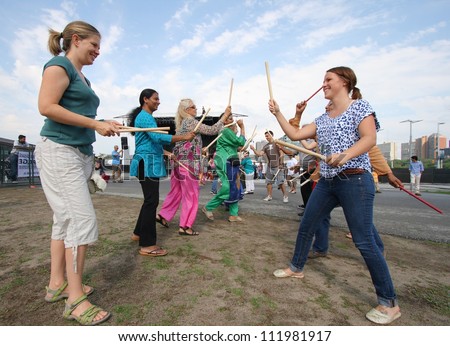 OTTAWA, CANADA-AUGUST 11: People playing Dandiya at the Festival of India on August 11, 2012 in Ottawa, Ontario. Dandiya is an Indian dance where participants bang sticks together to music.