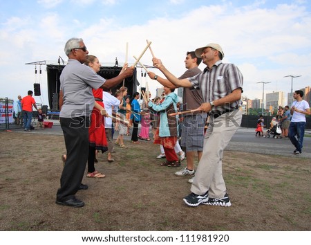 OTTAWA, CANADA-AUGUST 11: People playing Dandiya at the Festival of India on August 11, 2012 in Ottawa, Ontario. Dandiya is an Indian dance where participants bang sticks together to music.