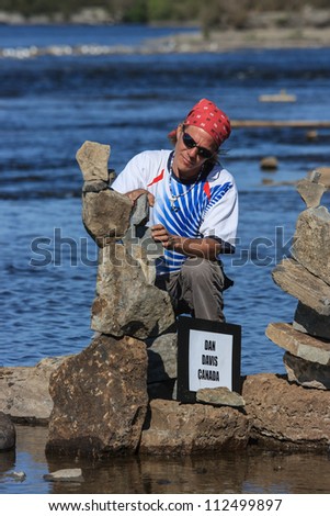 OTTAWA, CANADA - AUGUST 18: Dan Davis of Canada balances stones while participating in the  International Stone Balance Festival on August 18, 2012 at Remic Rapids in Ottawa, Ontario.