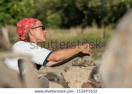 OTTAWA, CANADA - AUGUST 18: Dan Davis of Canada balancing stones while participating in the International Stone Balance Festival at Remic Rapids on August 18, 2012 in Ottawa, Ontario.