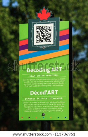 OTTAWA, CANADA - AUGUST 25: A sign with instructions and a QR code to obtain more information about the Colonel By statue in Major\'s Hill Park on August 25, 2012 in downtown Ottawa, Ontario.