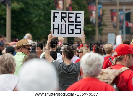 Ottawa, Canada - July 1: A Young Man Offering Free Hugs During Canada Day On July 1, 2013 In Downtown Ottawa, Ontario.