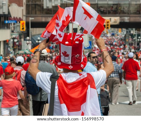 OTTAWA, CANADA - JULY 1: A street vendor with Canadian flags during Canada Day on July 1, 2013 in downtown Ottawa, Ontario.