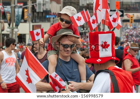 Ottawa, Canada - July 1: A Man Buying Canadian Flags For His Family During Canada Day On July 1, 2013 In Downtown Ottawa, Ontario.