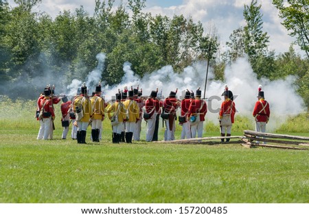 MORRISBURG, CANADA - JULY 14: Men firing guns during the Battle of Crysler\'s Farm reenactment on July 14, 2013 near Morrisburg, Ontario.