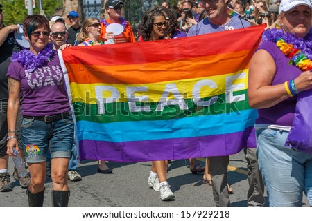 OTTAWA, CANADA - AUGUST 26:  People carrying a gay peace flag in the Capital Pride Parade on August 26, 2012 in Ottawa, Ontario.
