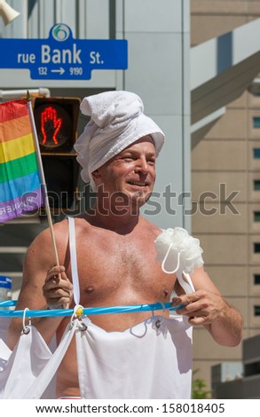 OTTAWA, CANADA - AUGUST 26: A man pretending to bathe in the Capital Pride Parade on August 26, 2012 in Ottawa, Ontario.