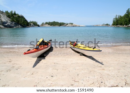 Two sea kayaks on the beach at Sinclair Cove. Lake Superior Provincial Park, Ontario.