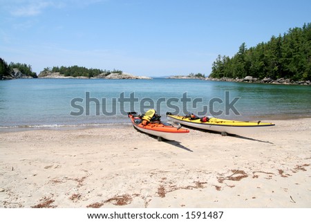 Two sea kayaks on the beach at Sinclair Cove. Lake Superior Provincial Park, Ontario.