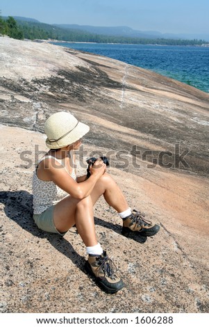 Female hiker with camera on Coastal Trail. Lake Superior Provincial Park, Ontario.