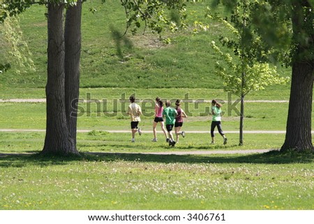 People jogging through a city park. Ottawa, Ontario. Canada.