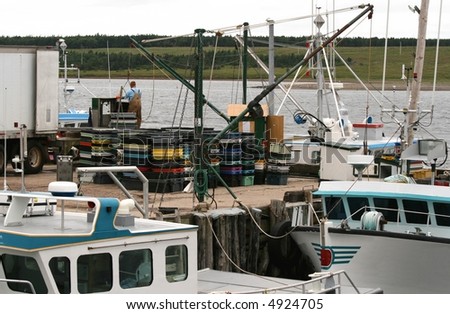 Man crates of seafood onto transport truck. Cheticamp, Nova Scotia. Canada.